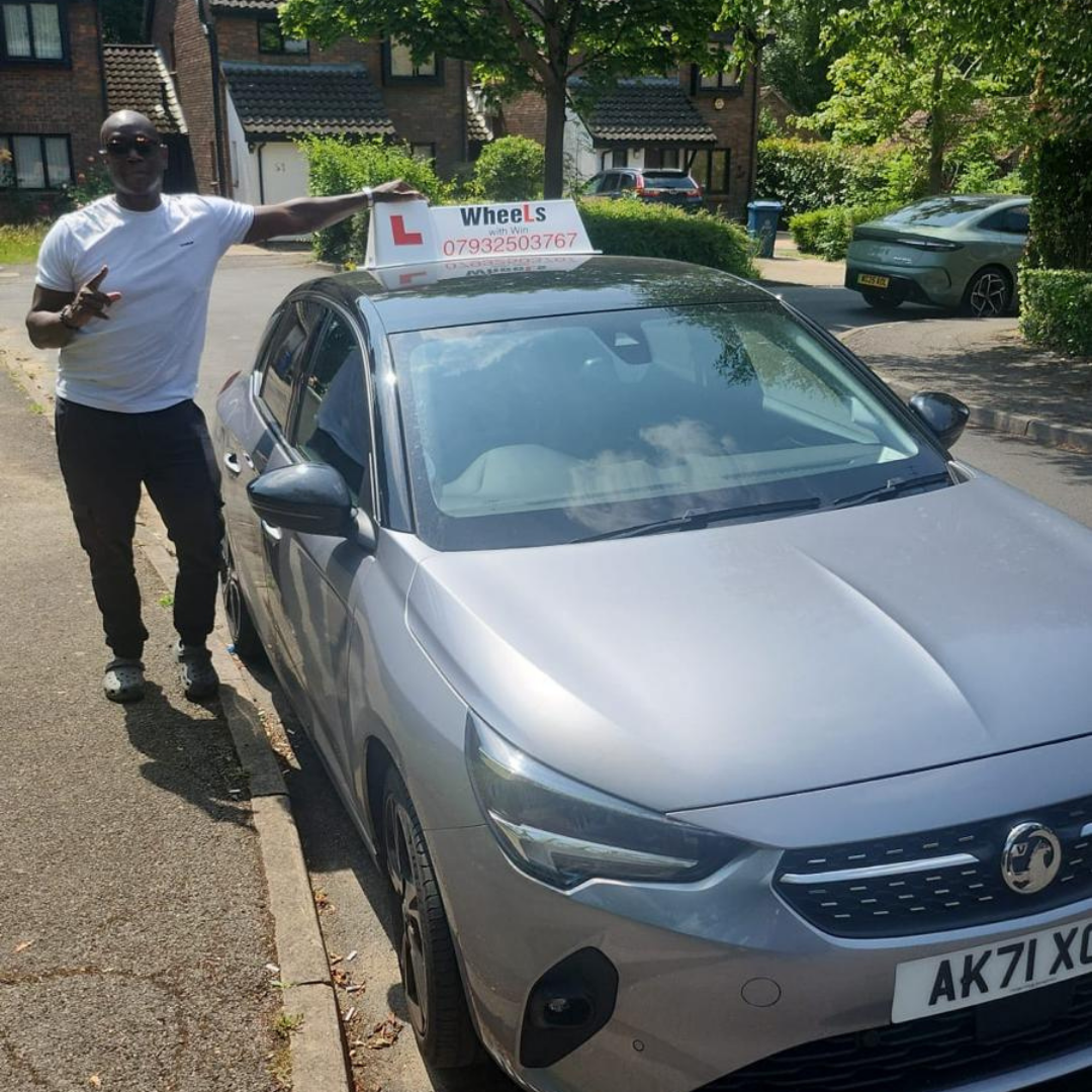 Winston beside the Wheels With Win driving school car