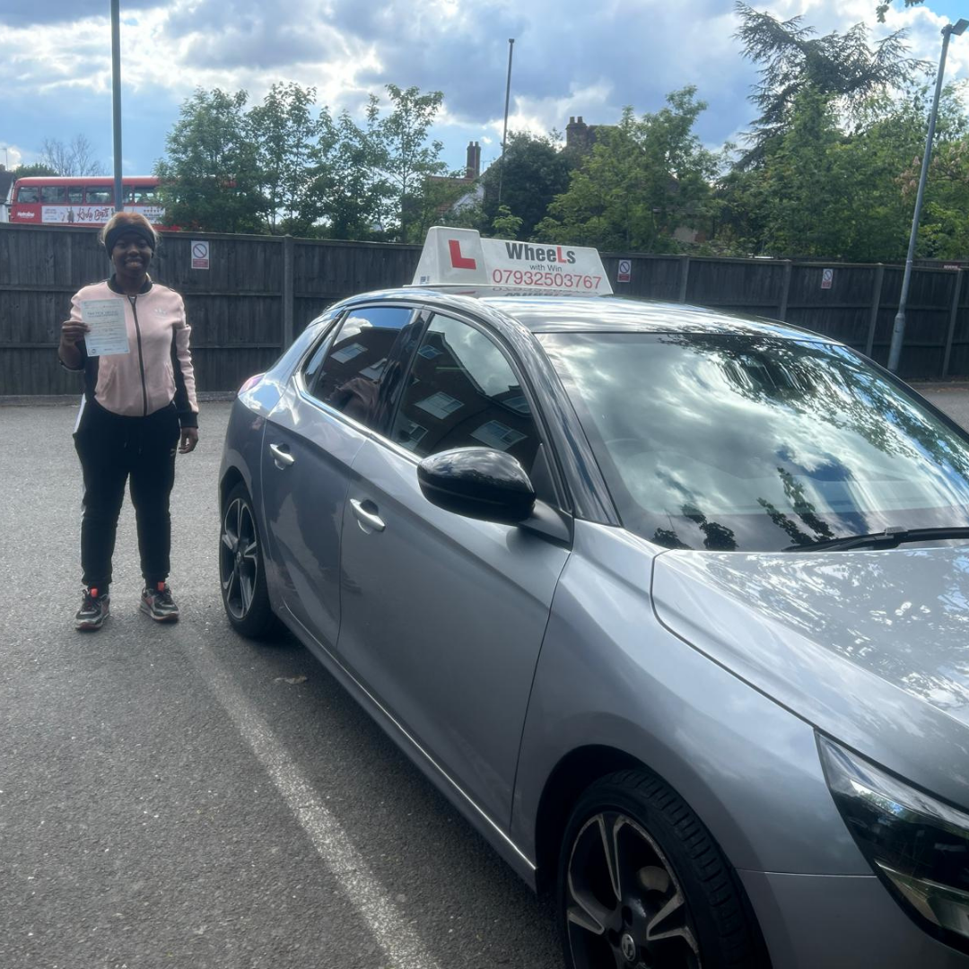 Anuska beside the Wheels With Win learner car