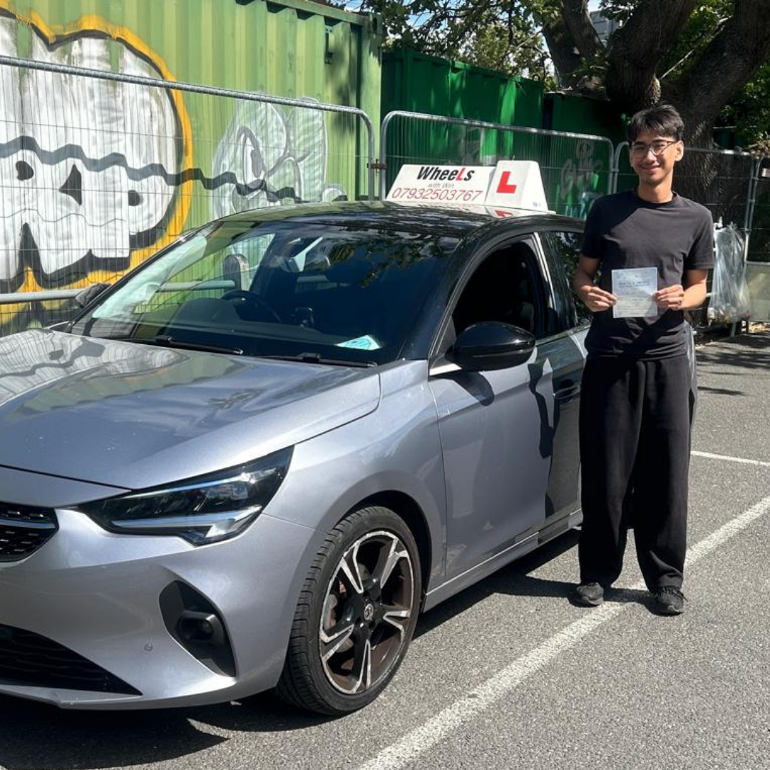 Joshua beside the Wheels With Win learner car
